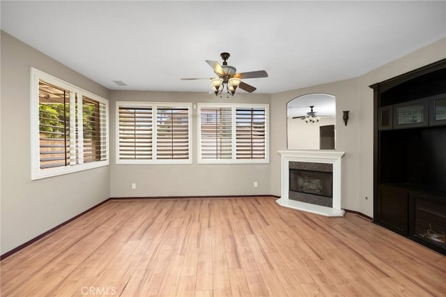 12975 Cambridge Ct, Chino, CA 91710 - unfurnished living room featuring a ceiling fan, light wood-type flooring, and a premium fireplace