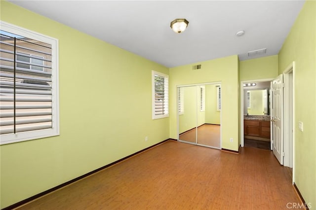 12975 Cambridge Ct, Chino, CA 91710 - unfurnished bedroom with a closet and wood finished floors