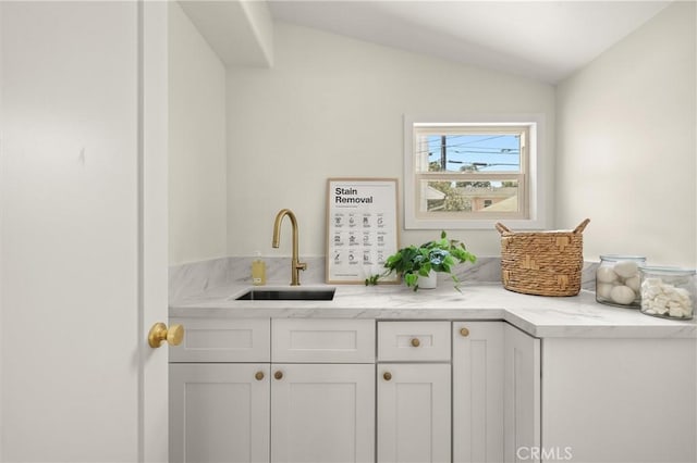 4131 Edgehill Dr, Los Angeles, CA 90008 - kitchen featuring lofted ceiling, white cabinetry, and light stone countertops