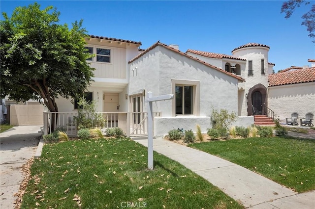 4131 Edgehill Dr, Los Angeles, CA 90008 - mediterranean / spanish-style house with a front lawn, a tiled roof, stucco siding, and a gate