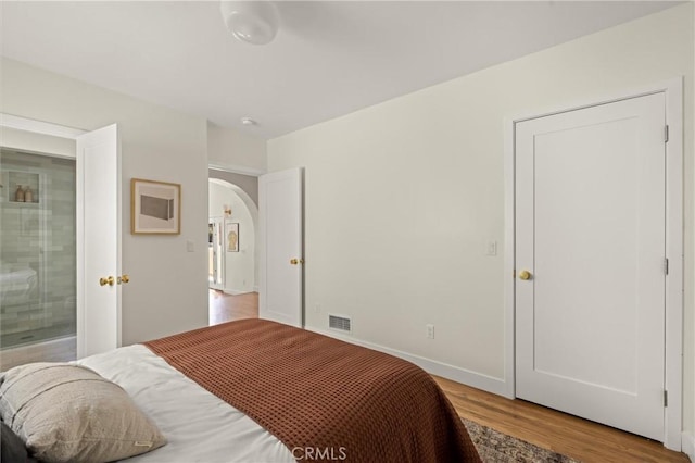 4131 Edgehill Dr, Los Angeles, CA 90008 - bedroom with arched walkways and wood finished floors