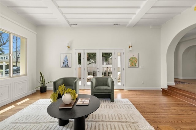 4131 Edgehill Dr, Los Angeles, CA 90008 - living room with french doors, arched walkways, and light wood-style flooring