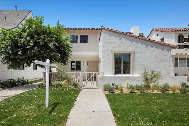 4131 Edgehill Dr, Los Angeles, CA 90008 - view of front of house with a front lawn, stucco siding, a chimney, and a tile roof