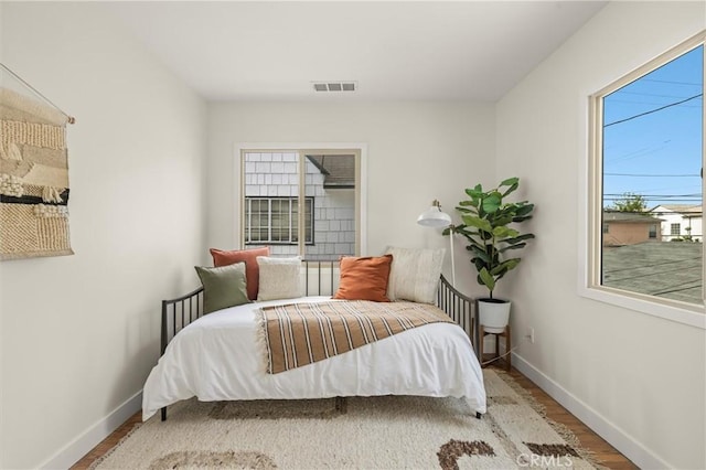 4131 Edgehill Dr, Los Angeles, CA 90008 - bedroom featuring multiple windows and wood finished floors