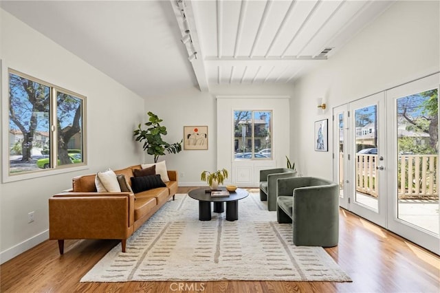 4131 Edgehill Dr, Los Angeles, CA 90008 - living room featuring plenty of natural light, light wood-style flooring, french doors, and beamed ceiling
