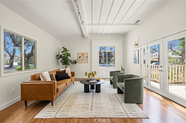 4131 Edgehill Dr, Los Angeles, CA 90008 - living room featuring light wood-style flooring, french doors, and beam ceiling