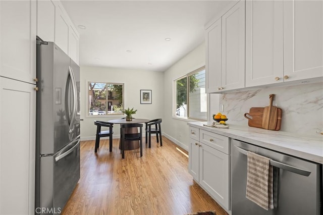 4131 Edgehill Dr, Los Angeles, CA 90008 - kitchen featuring appliances with stainless steel finishes, white cabinets, light wood finished floors, decorative backsplash, and recessed lighting