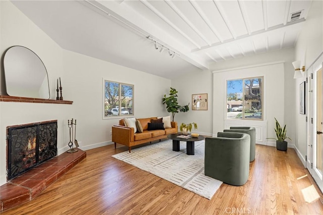 4131 Edgehill Dr, Los Angeles, CA 90008 - living room featuring light wood finished floors and a warm lit fireplace