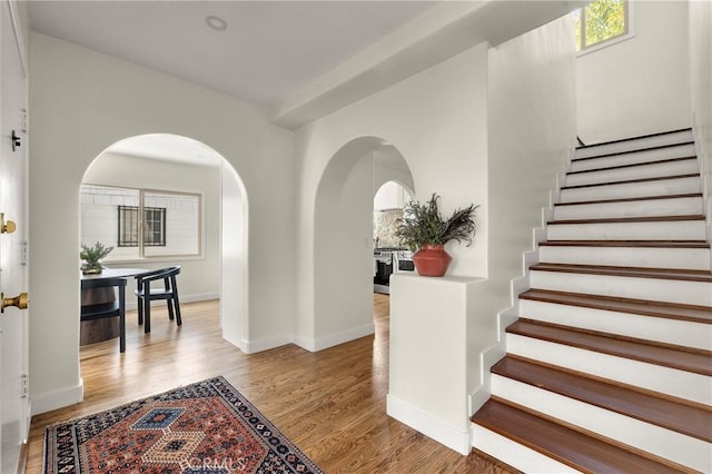 4131 Edgehill Dr, Los Angeles, CA 90008 - entryway featuring arched walkways, stairs, and wood finished floors