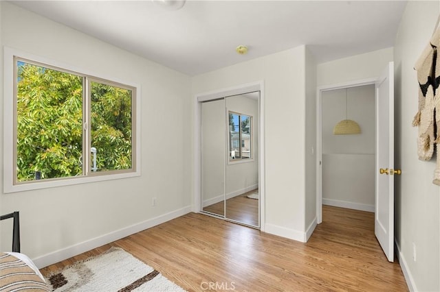 4131 Edgehill Dr, Los Angeles, CA 90008 - unfurnished bedroom with light wood-type flooring and a closet