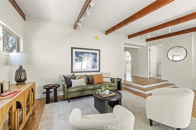 4131 Edgehill Dr, Los Angeles, CA 90008 - living area with light wood-style flooring, rail lighting, arched walkways, plenty of natural light, and beamed ceiling