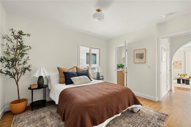 4131 Edgehill Dr, Los Angeles, CA 90008 - bedroom with light wood-type flooring and arched walkways