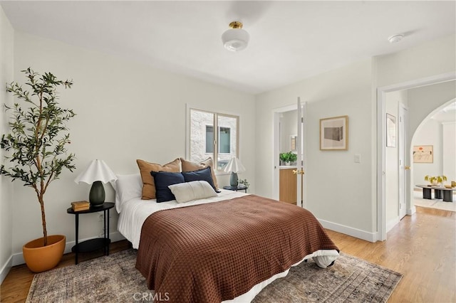 4131 Edgehill Dr, Los Angeles, CA 90008 - bedroom with light wood-type flooring and arched walkways