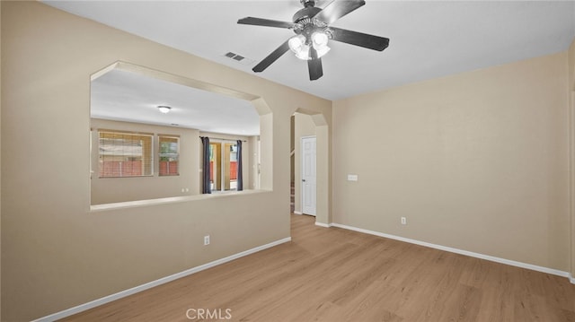 3360 Hammock St, Perris, CA 92571 - spare room featuring light wood finished floors, ceiling fan, and arched walkways
