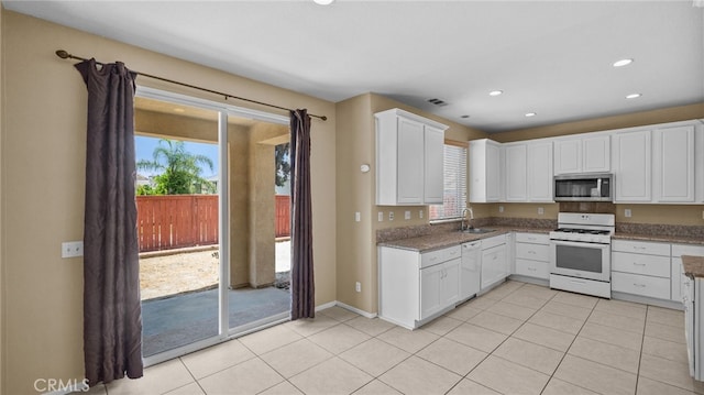3360 Hammock St, Perris, CA 92571 - kitchen with white appliances, plenty of natural light, light tile patterned floors, and recessed lighting