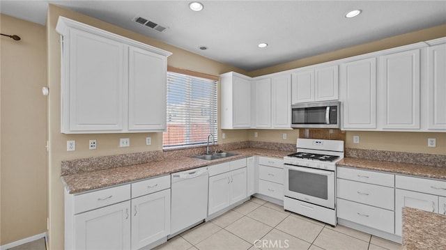 3360 Hammock St, Perris, CA 92571 - kitchen featuring white appliances, white cabinets, recessed lighting, and light tile patterned flooring
