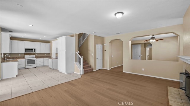 3360 Hammock St, Perris, CA 92571 - kitchen featuring white range, ceiling fan, light wood-style floors, open floor plan, and recessed lighting