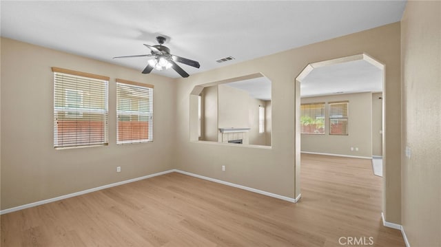 3360 Hammock St, Perris, CA 92571 - spare room with light wood finished floors, a ceiling fan, and arched walkways