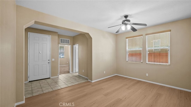 3360 Hammock St, Perris, CA 92571 - entrance foyer with light wood-style floors, a ceiling fan, and arched walkways