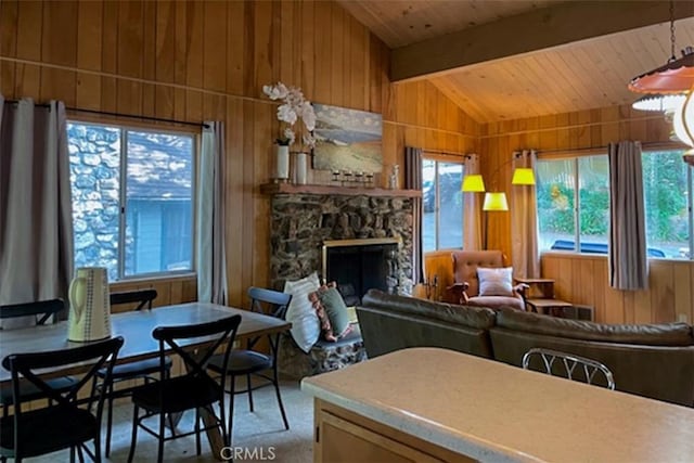 22908 Redwood Way, Crestline, CA 92325 - living room with wooden walls, healthy amount of natural light, wood ceiling, and a stone fireplace