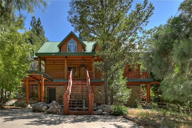 29729 Katherine Way, Cedar Glen, CA 92321 - view of front of home featuring stone siding, covered porch, stairway, a metal roof, and faux log siding