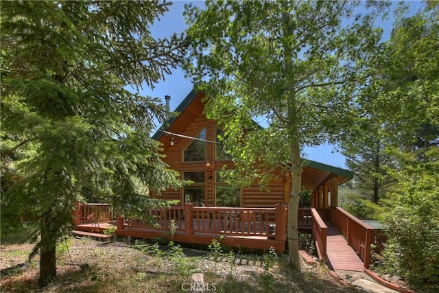 29729 Katherine Way, Cedar Glen, CA 92321 - rear view of house with faux log siding and a wooden deck