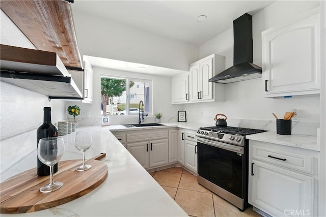 236 N Michigan Ave, Pasadena, CA 91106 - kitchen with gas stove, wall chimney exhaust hood, light countertops, white cabinets, and light tile patterned flooring