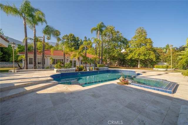 275 E 24th St, Upland, CA 91784 - view of swimming pool featuring a pool with connected hot tub and a patio area