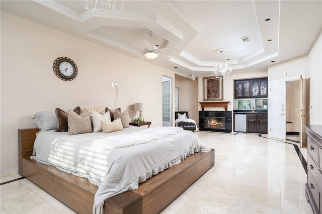275 E 24th St, Upland, CA 91784 - bedroom featuring a chandelier, a raised ceiling, a glass covered fireplace, and ceiling fan