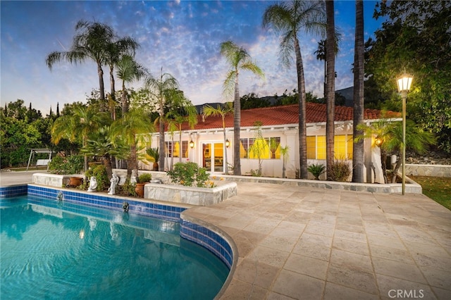 275 E 24th St, Upland, CA 91784 - pool at dusk with french doors, an outdoor pool, and a patio