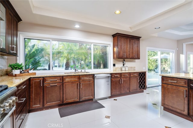 275 E 24th St, Upland, CA 91784 - kitchen featuring stainless steel appliances, a tray ceiling, healthy amount of natural light, light stone counters, and recessed lighting