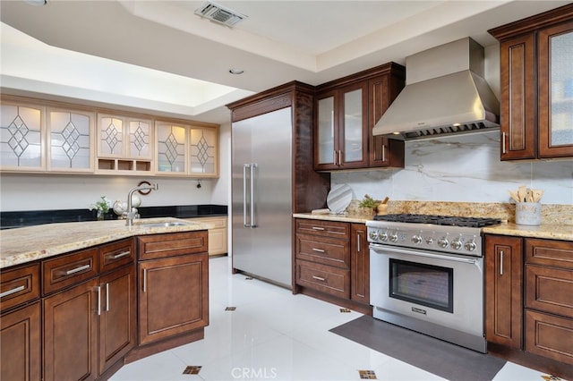 275 E 24th St, Upland, CA 91784 - kitchen with wall chimney range hood, high end appliances, a raised ceiling, and light stone countertops