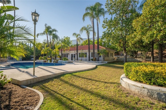 275 E 24th St, Upland, CA 91784 - rear view of property featuring a lawn and an outdoor pool