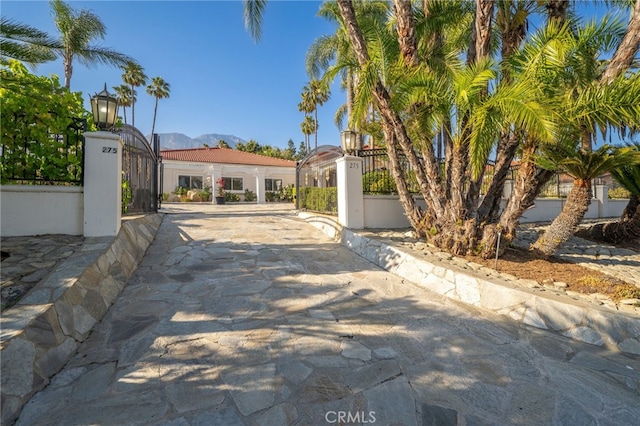 275 E 24th St, Upland, CA 91784 - view of front of property featuring a tiled roof, a gate, stucco siding, and a mountain view