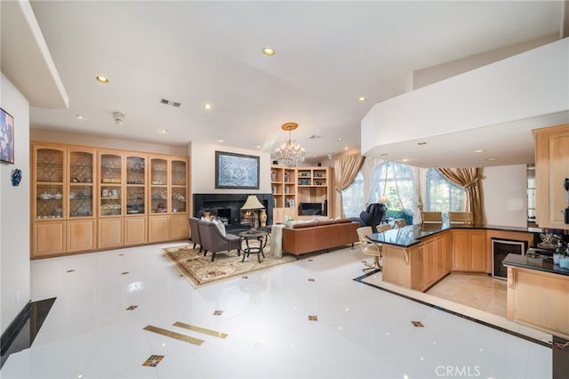 275 E 24th St, Upland, CA 91784 - kitchen featuring recessed lighting, a fireplace, wine cooler, dark countertops, and a chandelier