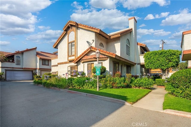 120 Poxon Pl, West Covina, CA 91790 - view of front of home featuring a tile roof, stucco siding, an attached garage, a chimney, and driveway
