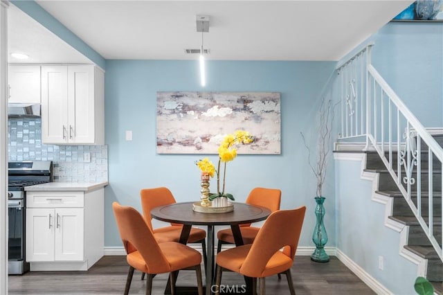 120 Poxon Pl, West Covina, CA 91790 - dining area with dark wood-style flooring and stairway