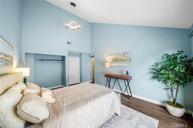 120 Poxon Pl, West Covina, CA 91790 - bedroom featuring wood finished floors, high vaulted ceiling, a chandelier, and a closet