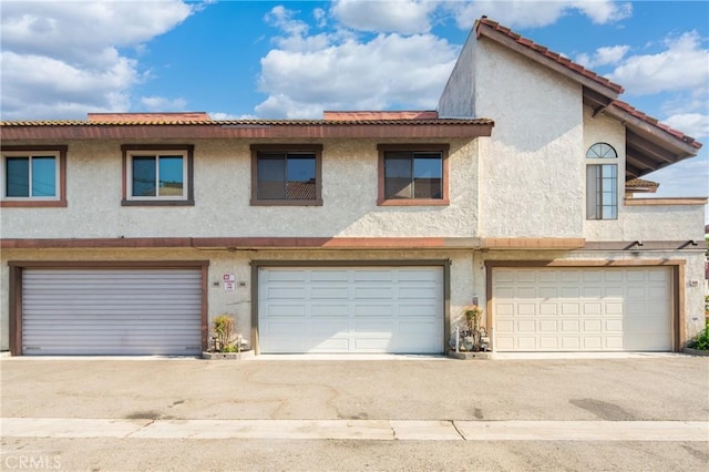 120 Poxon Pl, West Covina, CA 91790 - view of front facade featuring stucco siding, a garage, a tiled roof, and driveway
