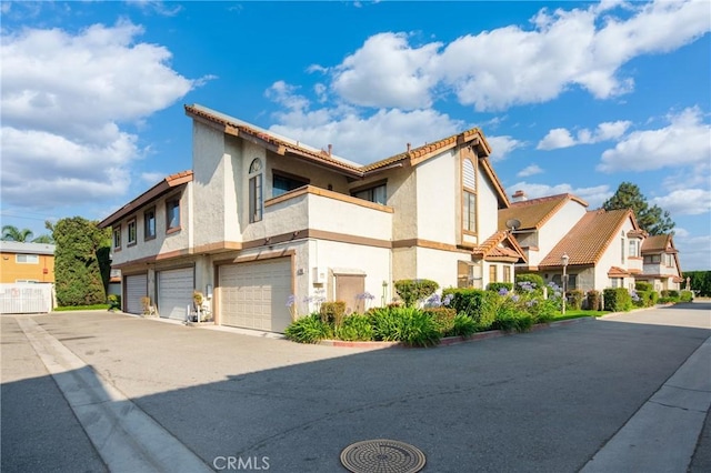 120 Poxon Pl, West Covina, CA 91790 - view of side of home featuring an attached garage, a balcony, stucco siding, and driveway