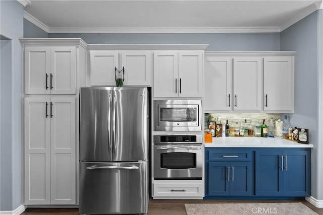 28518 High Ridge Dr, Saugus, CA 91390 - kitchen with appliances with stainless steel finishes, blue cabinets, light countertops, wood finished floors, and white cabinetry