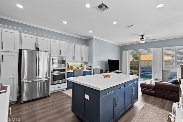28518 High Ridge Dr, Saugus, CA 91390 - kitchen with stainless steel appliances, open floor plan, white cabinets, blue cabinets, and recessed lighting