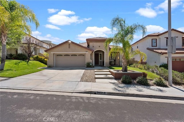 28518 High Ridge Dr, Saugus, CA 91390 - mediterranean / spanish house with stucco siding, a garage, driveway, a front lawn, and a tile roof