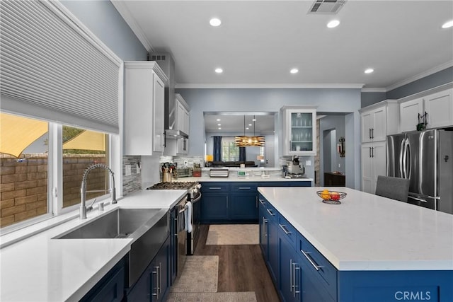 28518 High Ridge Dr, Saugus, CA 91390 - kitchen featuring appliances with stainless steel finishes, blue cabinets, healthy amount of natural light, recessed lighting, and crown molding
