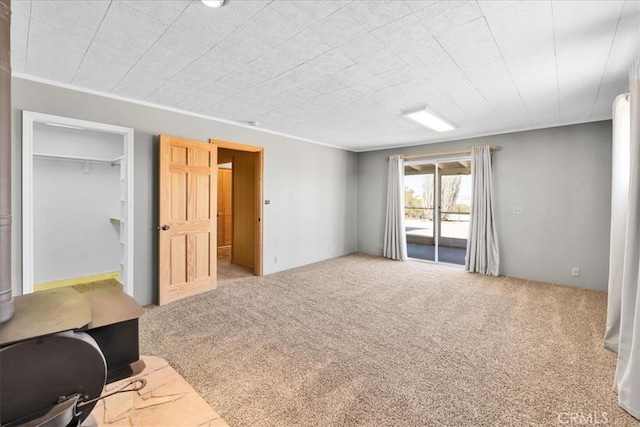 1638 Hales Dr Unit 29, Palms, CA 92277 - unfurnished bedroom with access to exterior, carpet floors, and a spacious closet