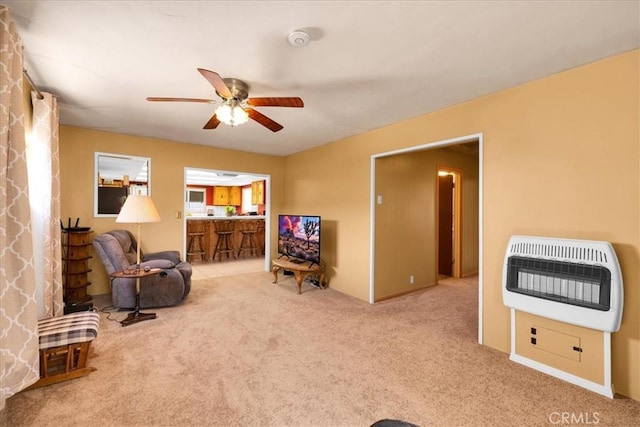 1638 Hales Dr Unit 29, Palms, CA 92277 - living area featuring heating unit, carpet, and a ceiling fan