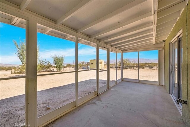 1638 Hales Dr Unit 29, Palms, CA 92277 - unfurnished sunroom featuring a mountain view and vaulted ceiling