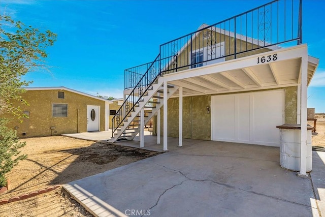 1638 Hales Dr Unit 29, Palms, CA 92277 - back of property with stairs, board and batten siding, and stucco siding