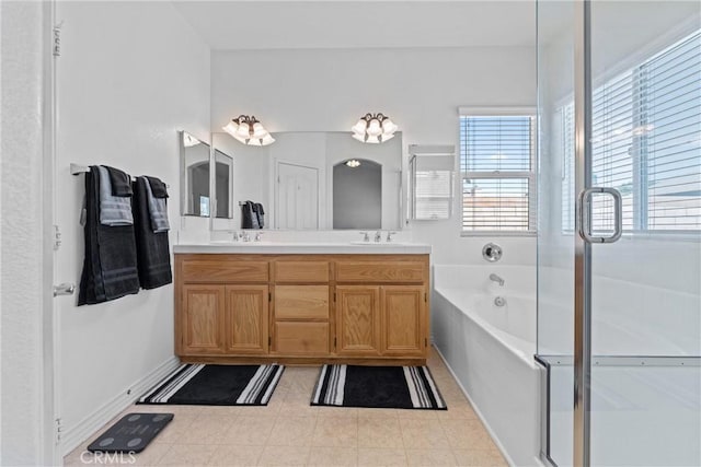 2041 Kalliope Ave, Lancaster, CA 93536 - bathroom featuring a bath, double vanity, a shower stall, and tile patterned flooring
