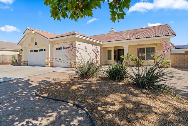 2041 Kalliope Ave, Lancaster, CA 93536 - view of front facade with a tiled roof, a garage, stucco siding, and driveway